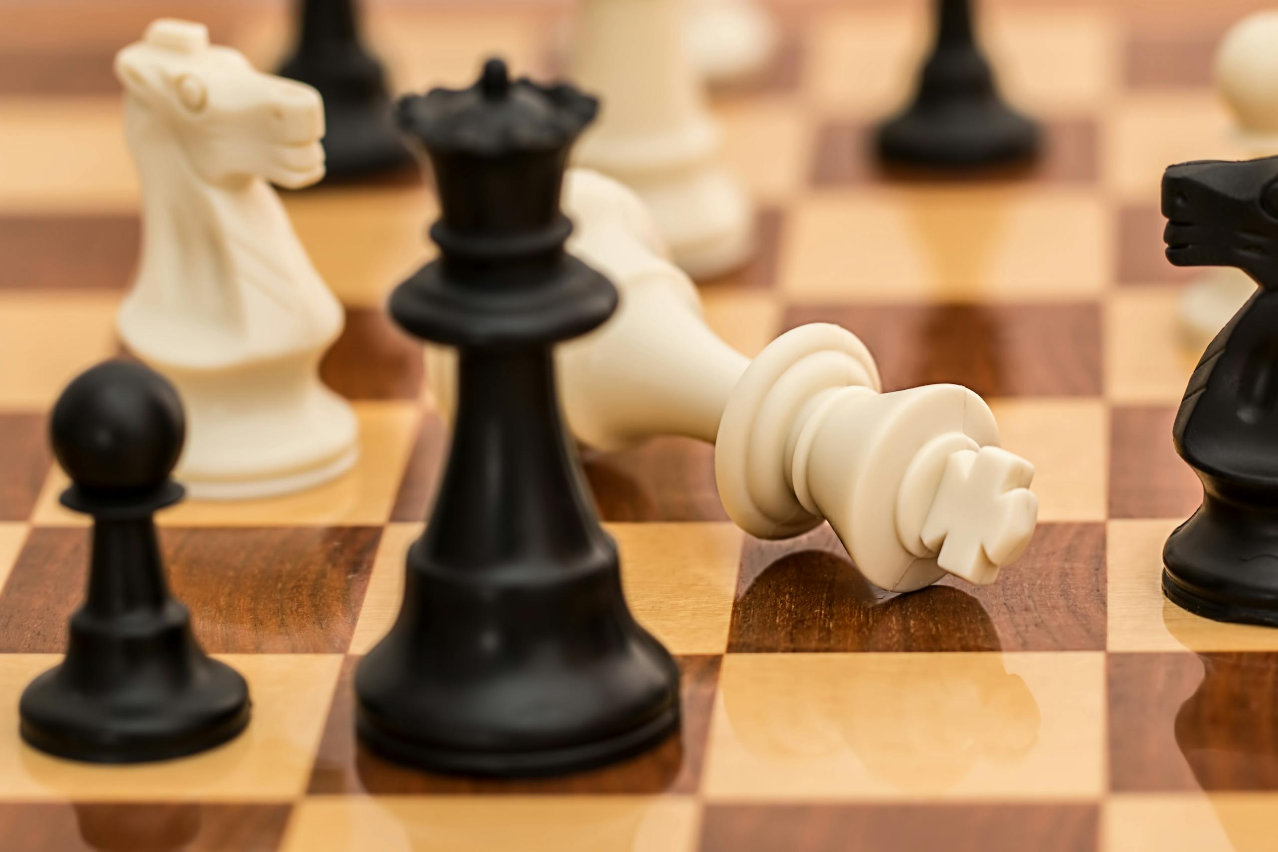 Close-up of chess pieces on a board depicting strategy and challenge.